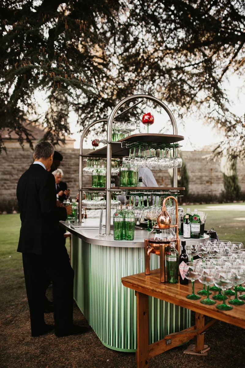 beautiful ombre green Gin bar underneath the cedar tree at elmore court for an outdoor wedding reception