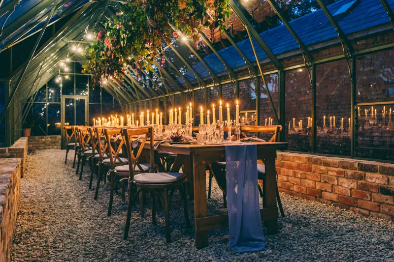 A candlelit dinner in a glasshouse, wedding inspiration by Elmore Court