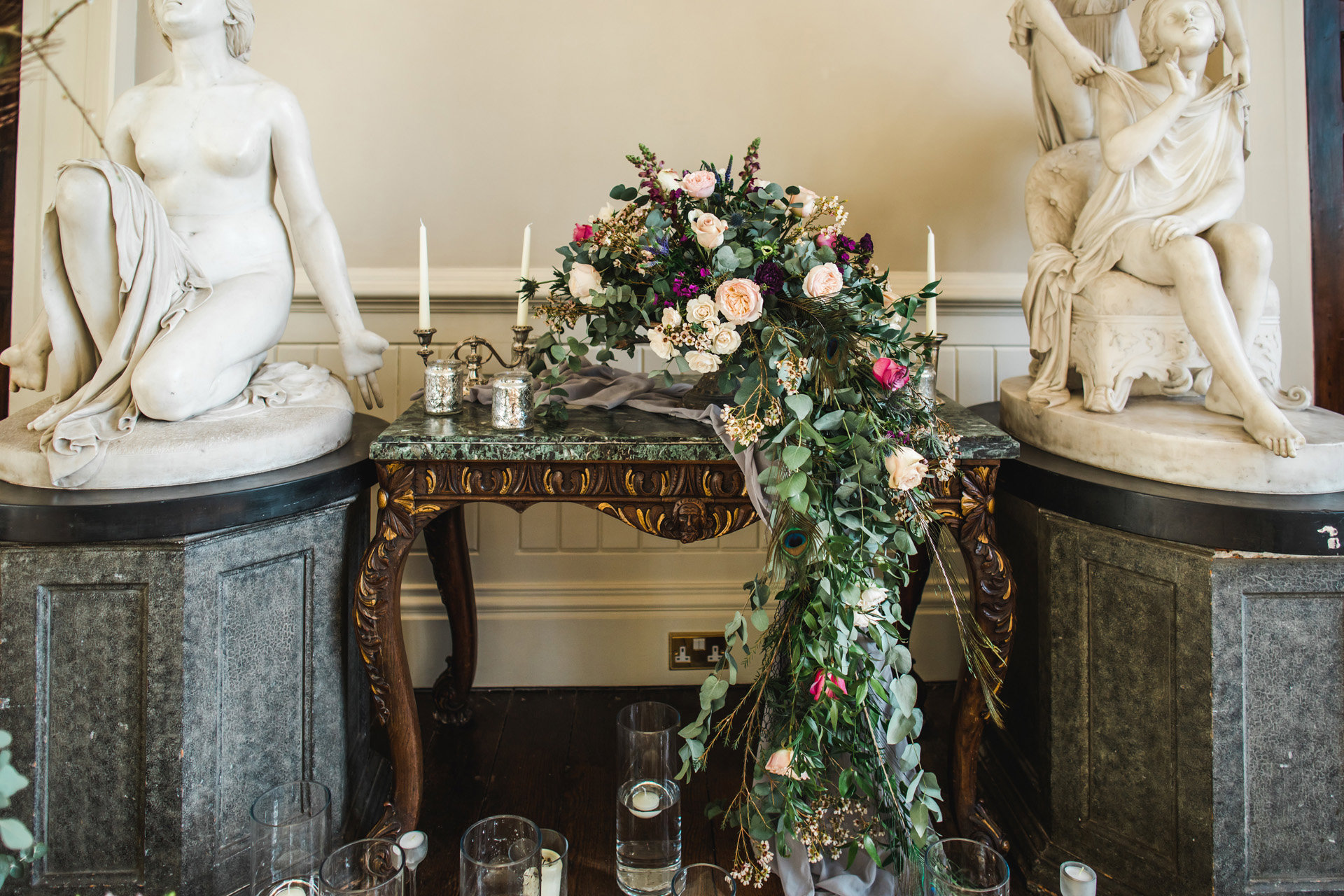 Trailing flower decor next to angel statues