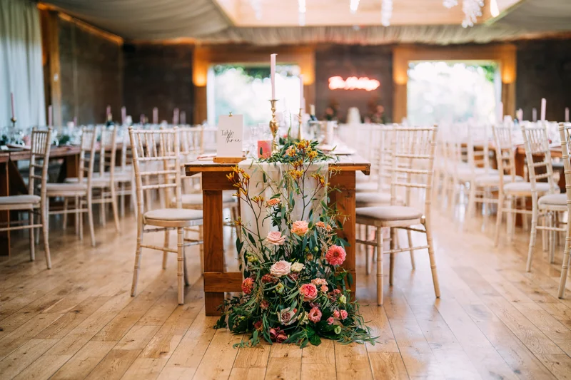 flower displays at the ends of long tables at a wedding reception party