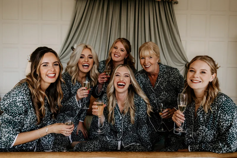 beautiful bridal party dressed in pyjama's enjoying a glass of bubbles on the morning of a wedding