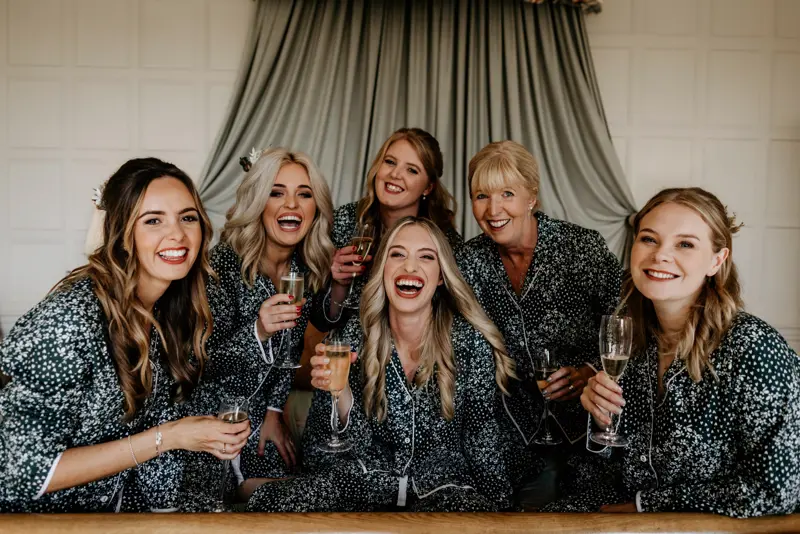 beautiful bridal party dressed in pyjama's enjoying a glass of bubbles on the morning of a wedding