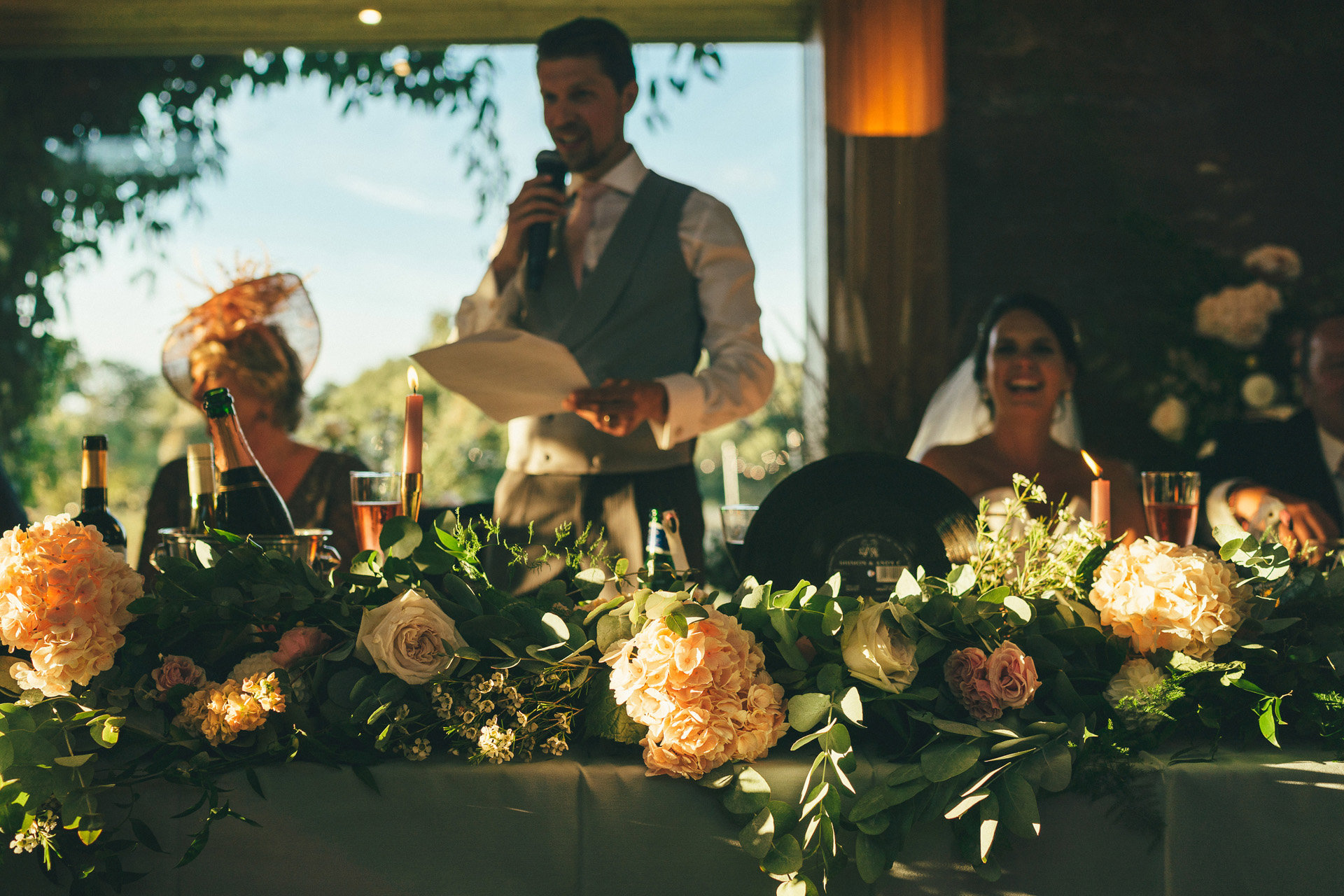 romantic wedding reception styling with pink roses and greenery