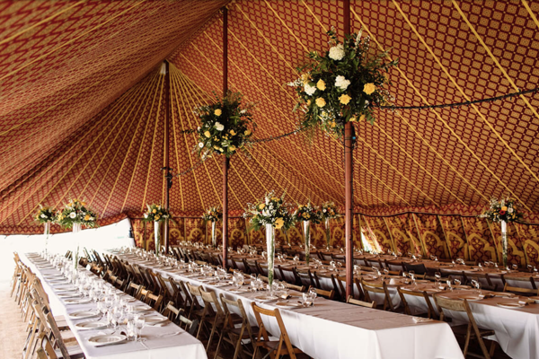 boho marquee for festival weddings with patterned inside and tables laid out for a reception