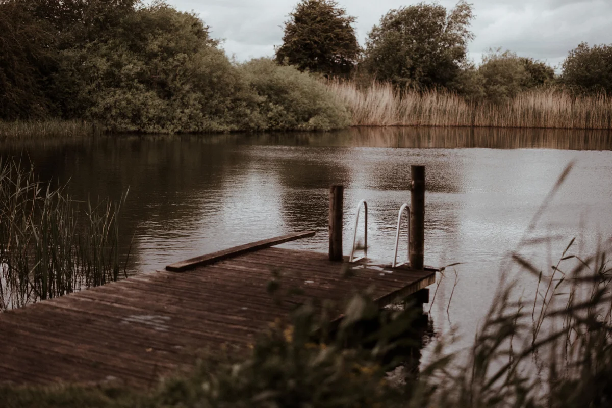 Swimming lake at rewilding wedding venue elmore court is open all year round for swims in spring fed water surrounded by countryside