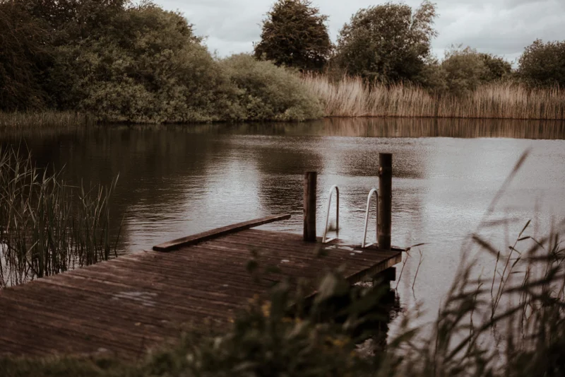 Swimming lake at rewilding wedding venue elmore court is open all year round for swims in spring fed water surrounded by countryside