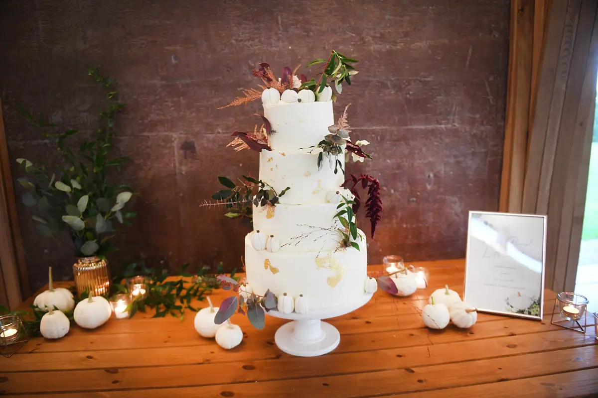 4 tier autumnal wedding cake with 4 flavours including pumpkin spice and decorated with mini fondant pumpkins for an october wedding
