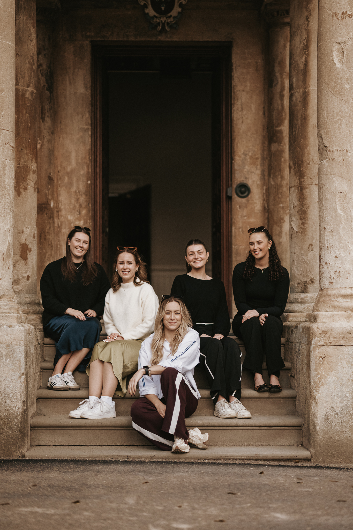 Team E pictured on the steps of Elmore Court