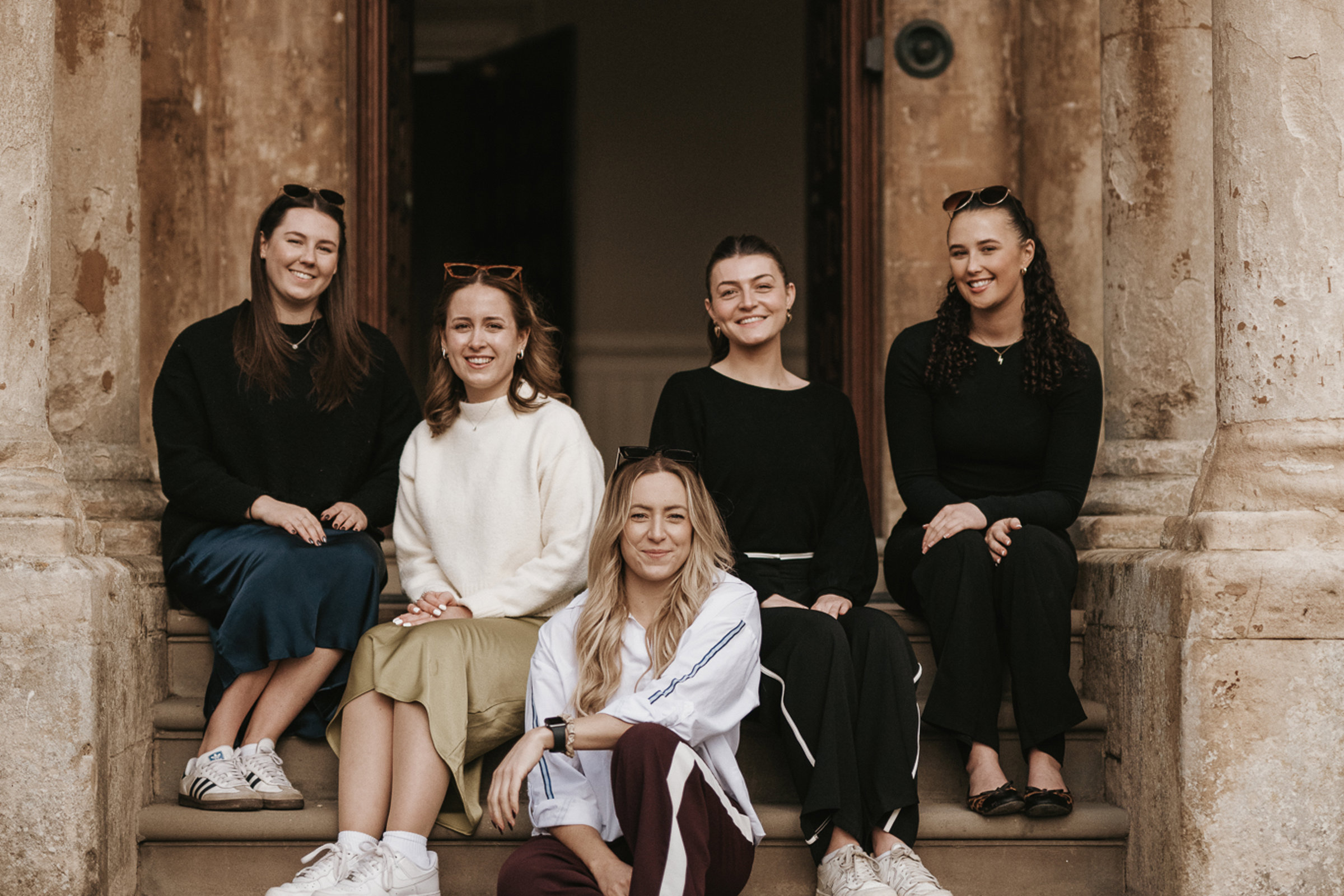 Team E pictured on the steps of Elmore Court