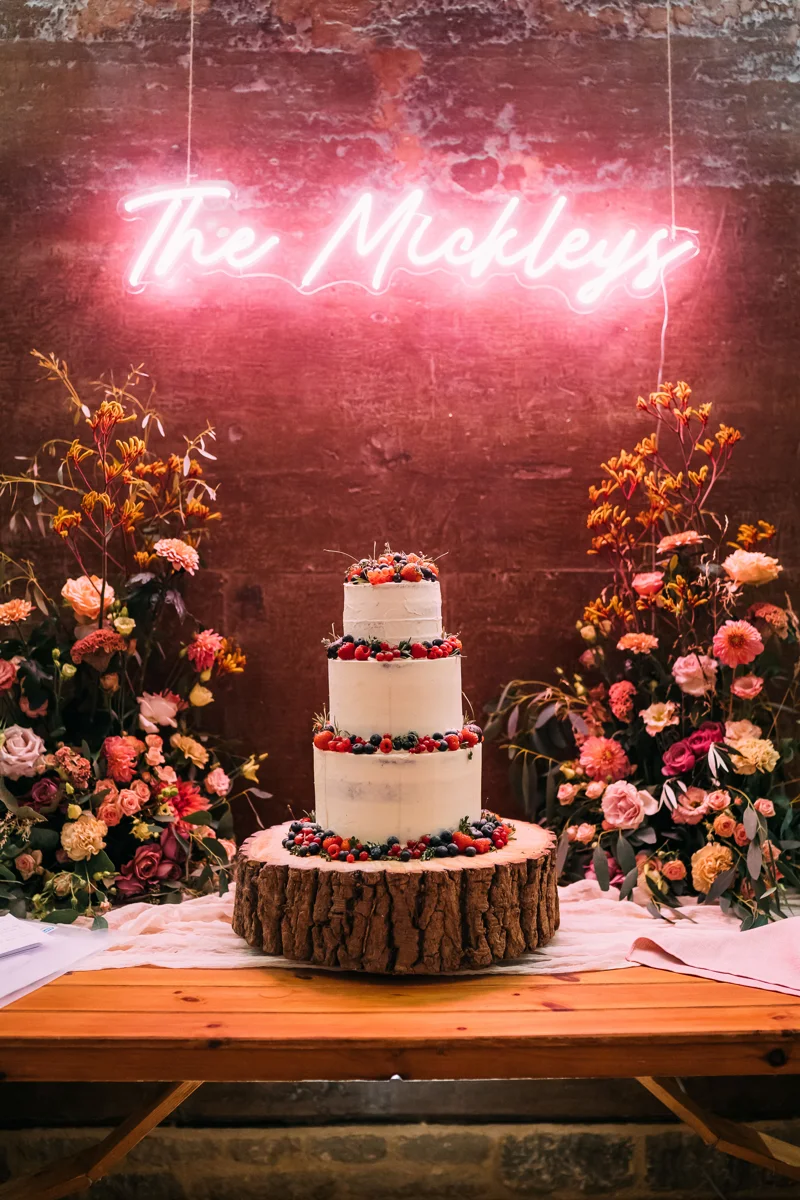 flower display around a wedding cake at Elmore Court