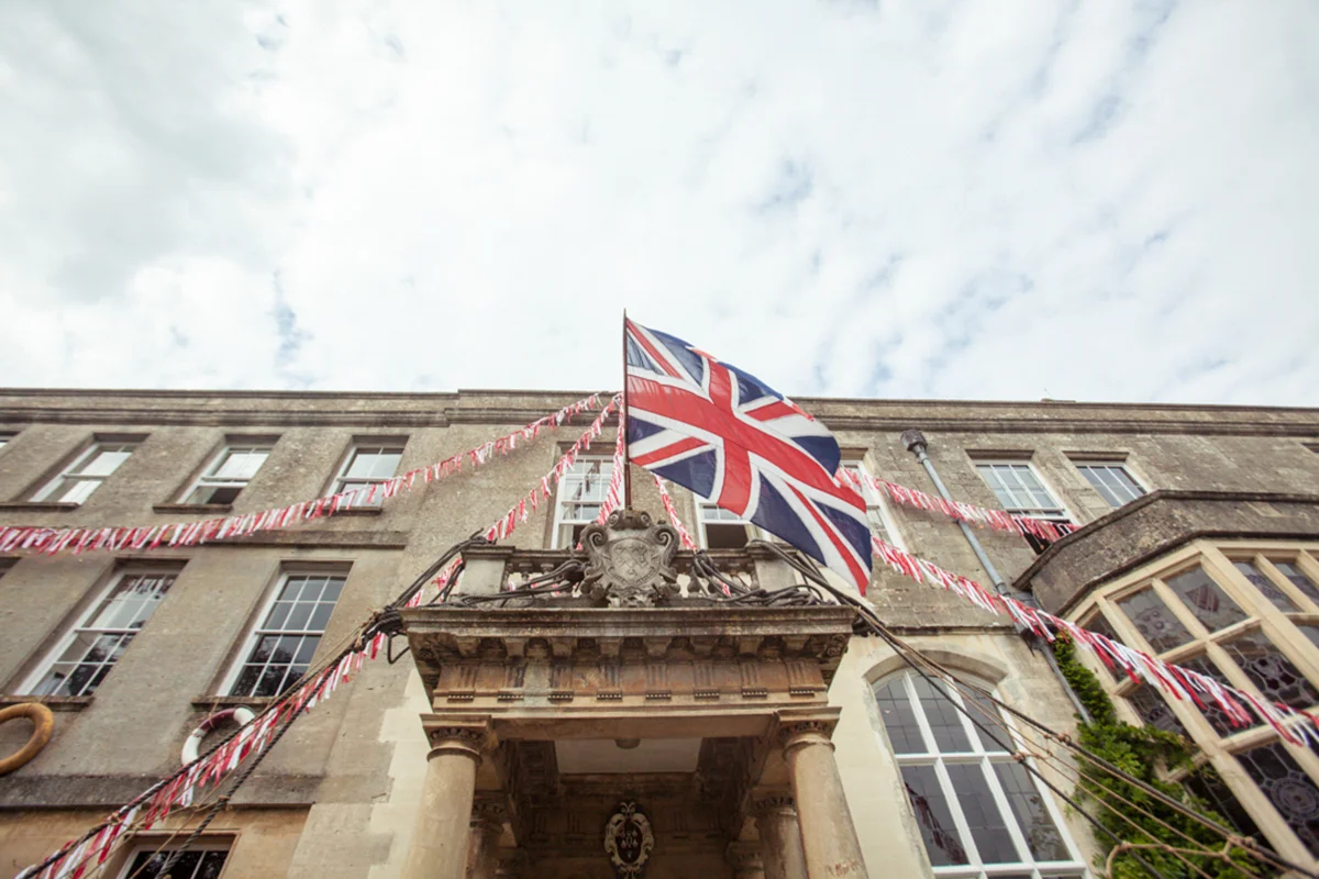 union jack bunting and english flag for a jubilee inspired wedding in manor house elmore court in the cotswolds