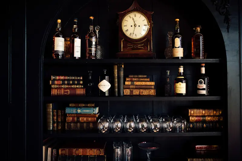Bookshelf full of antiques and old books in an old mansion house in the cotswolds, makes a very unusual place to stay