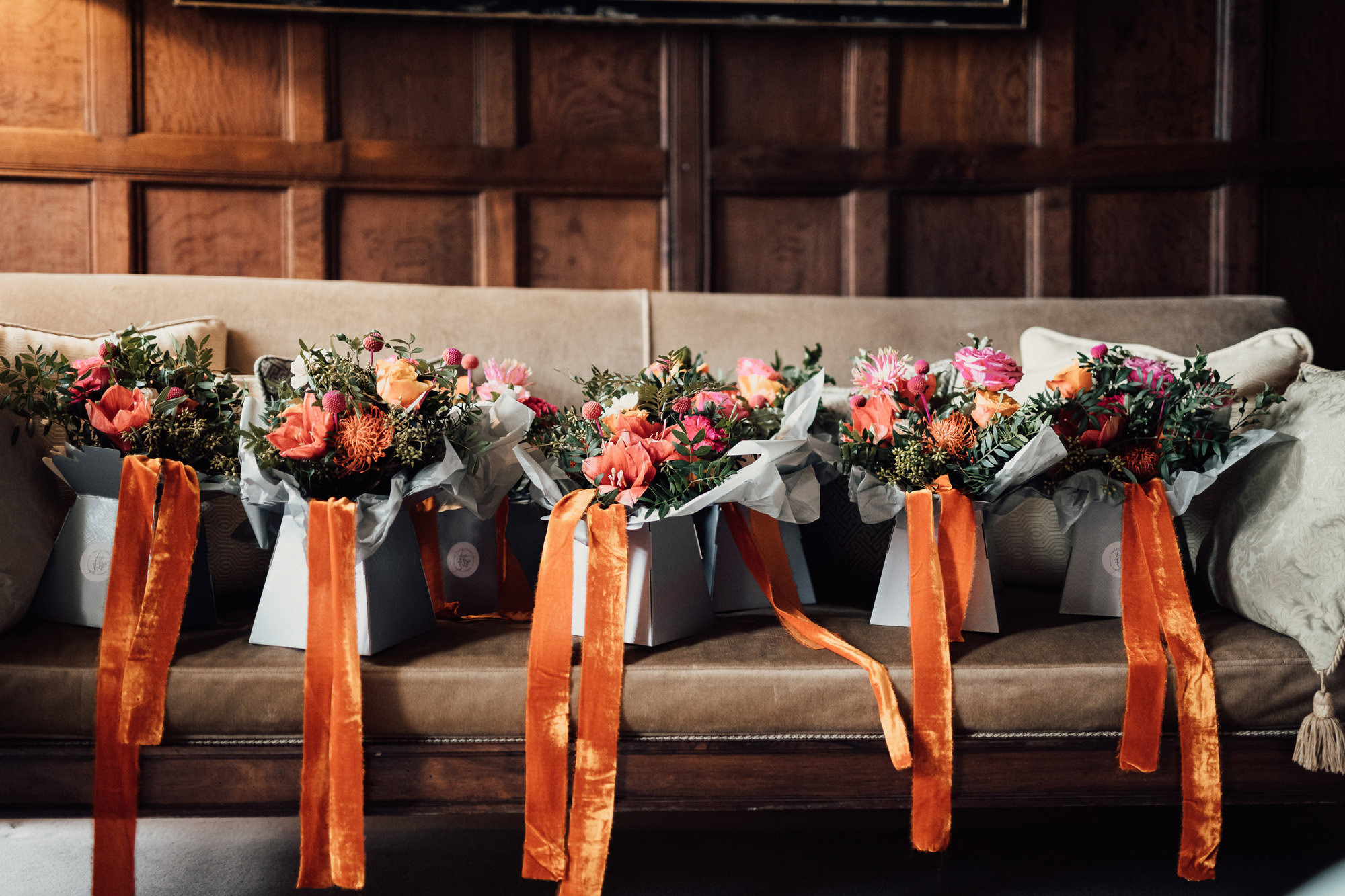 Beautiful bright bridal bouquets with orange ribbons ready for wedding