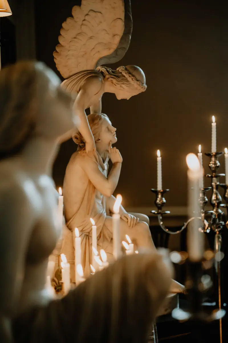 dark and moody wedding inspiration at candlelit wedding ceremony with huge angel statues
