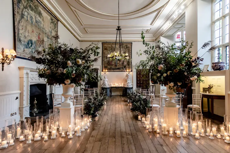 candle lit wedding ceremony in a great hall in a stately home