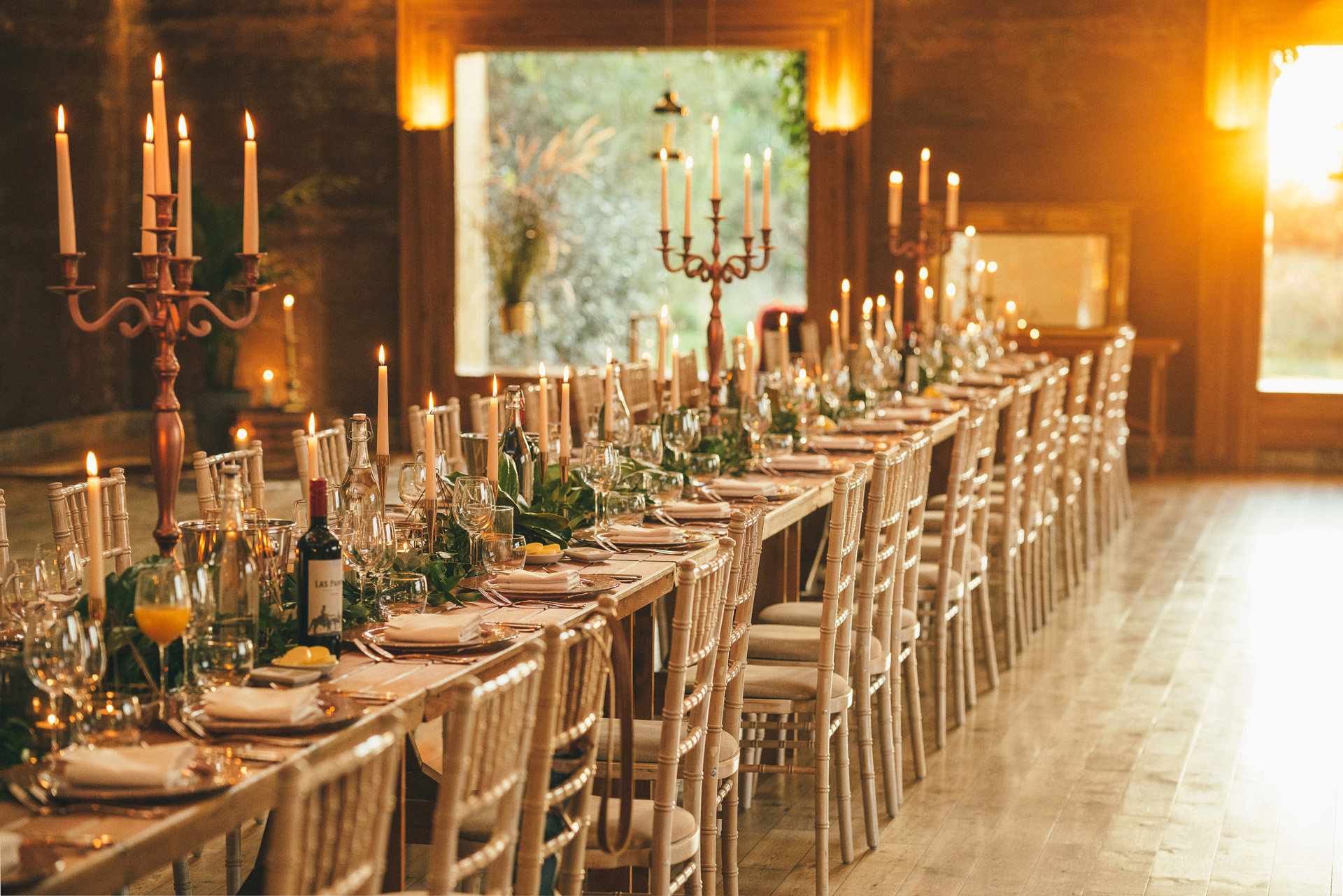 Candlelit Micro wedding reception dinner with banqueting table and candelabras