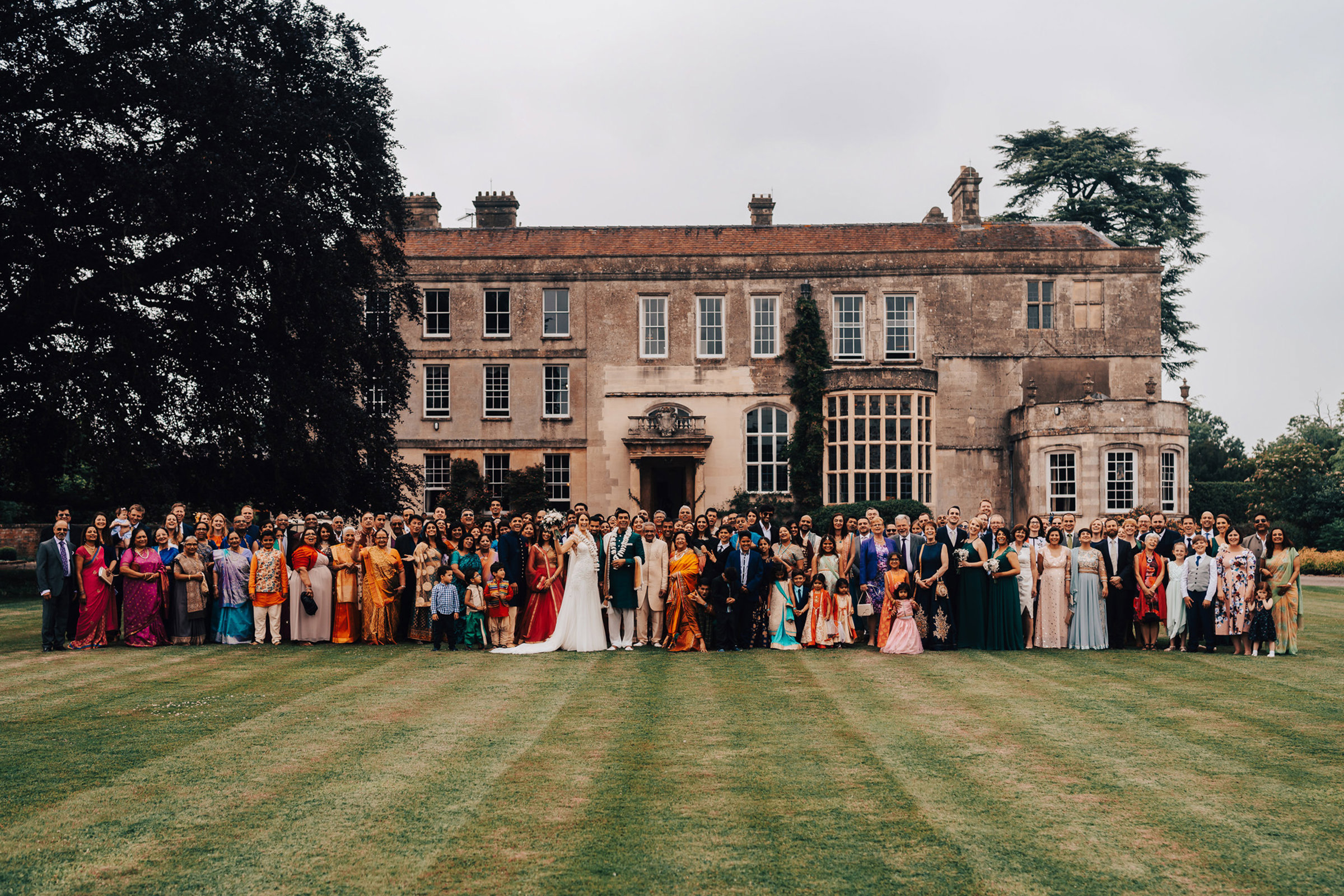 English Indian wedding venue with large group of guests outside