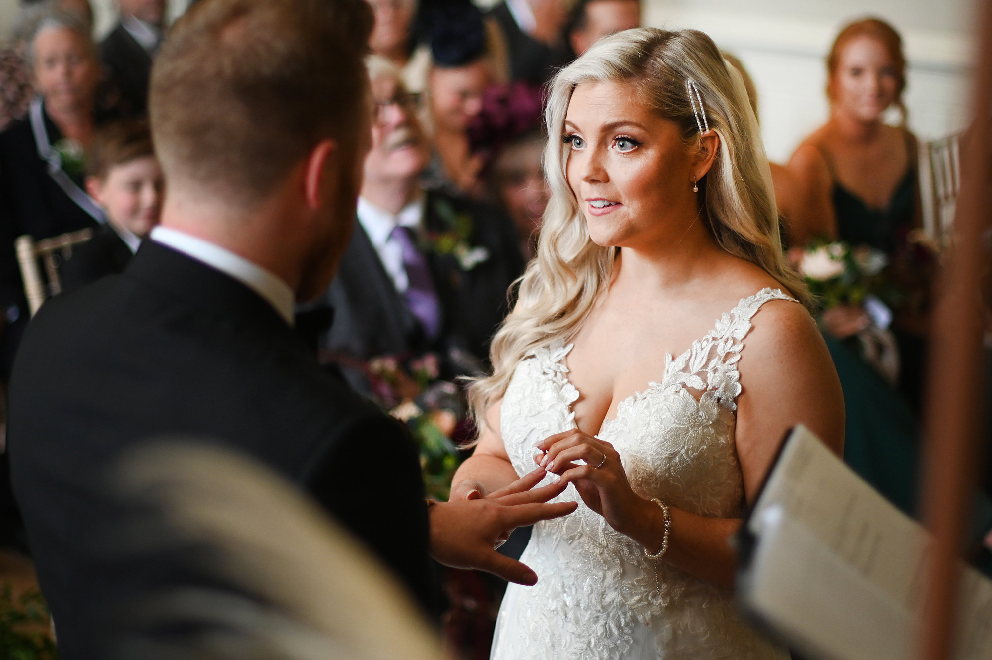 autumnal wedding ceremony bride and groom exchanging rings
