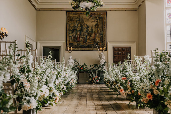Floral aisle for a luxe botanical wedding at stately home elmore court