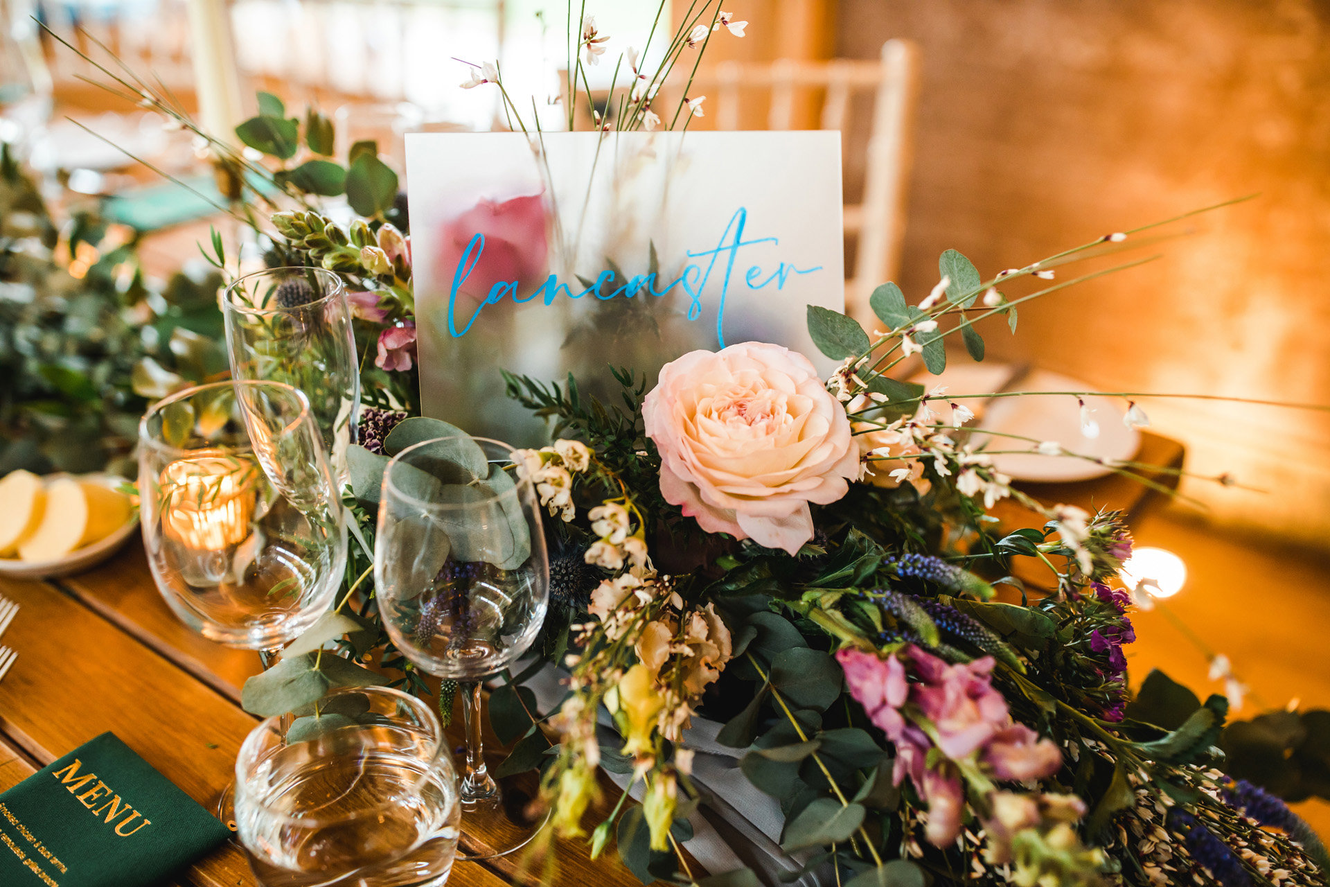 pink and green floral decor for table place names at a weekend wedding