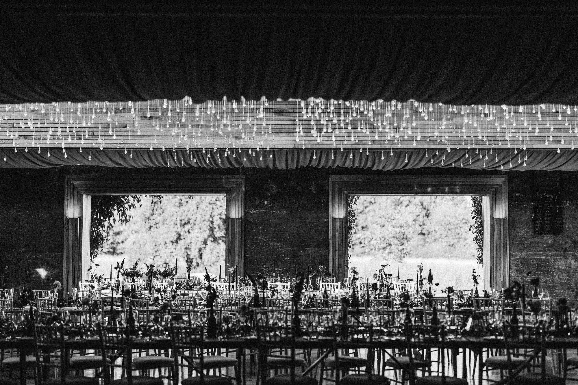 Moody photo of a modern wedding reception in October at sustainable wedding venue with halloween vibes