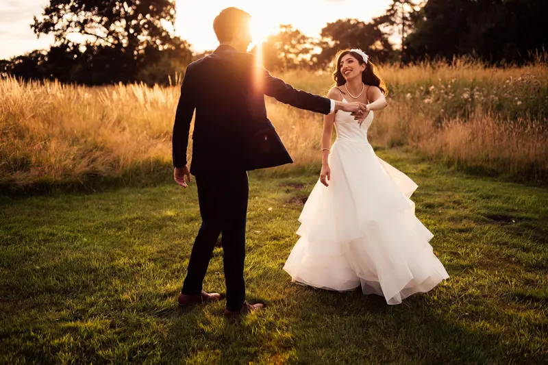 Engagement story how he proposed. Photo of bride and groom dancing at sunset outdoors at wild wedding venue elmore court