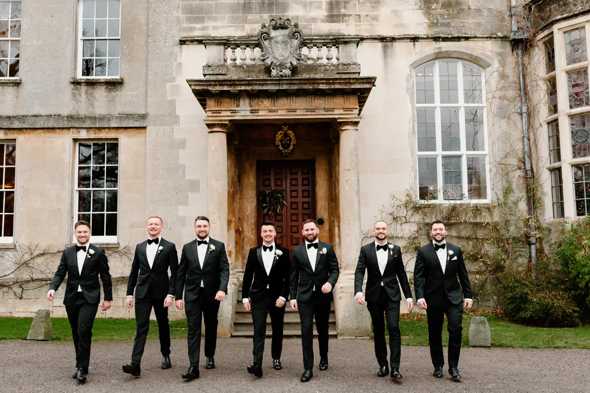groom and his groomsman lined up outside a stately home in Gloucestershire