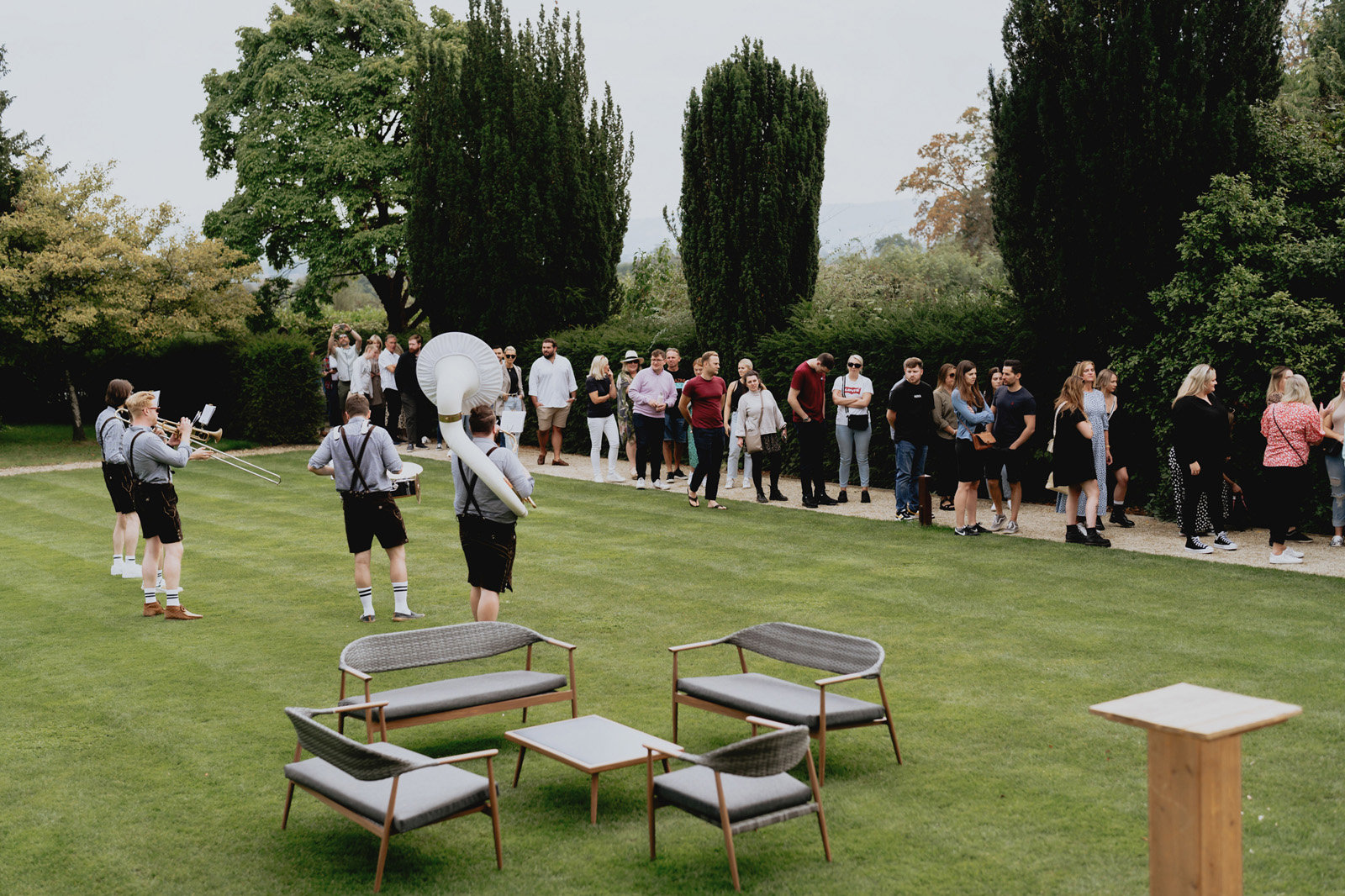 Little seating area on the lawn next to brass band for a wedding fair in the cotswolds