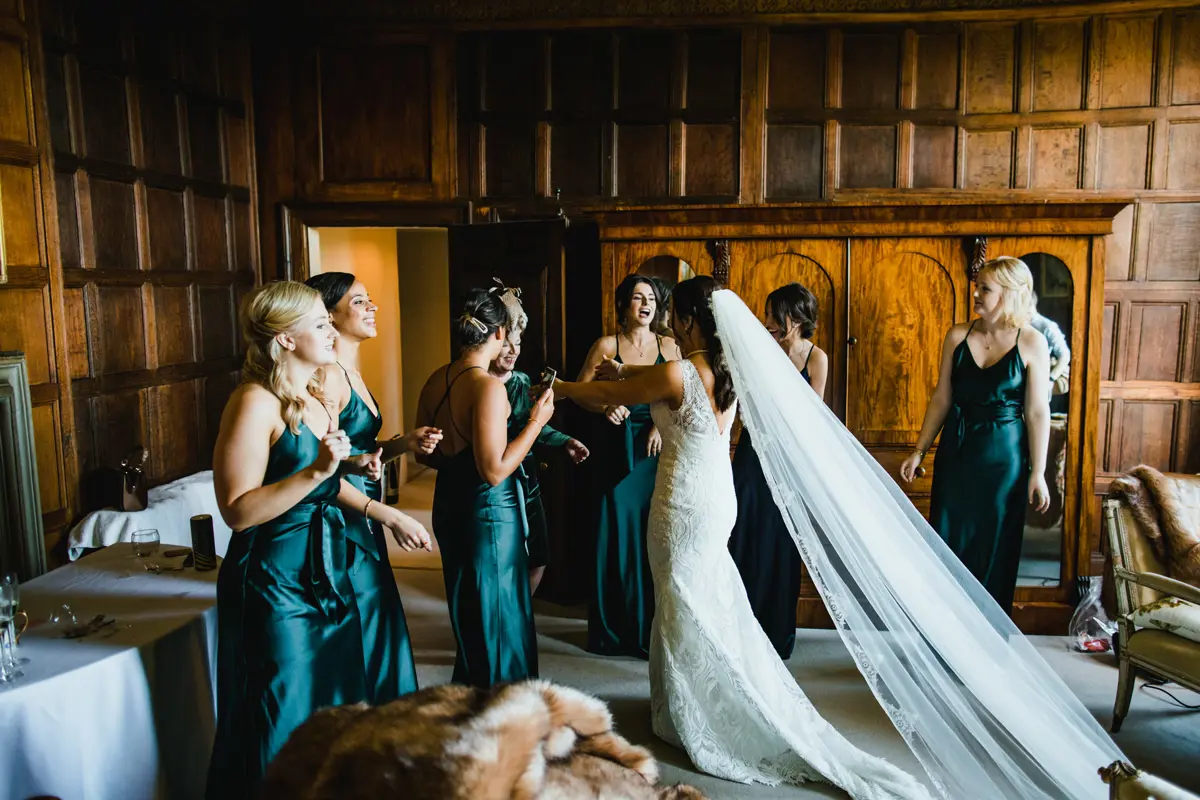Bridesmaids and bride having a pre wedding getting ready party in their weekend wedding venue