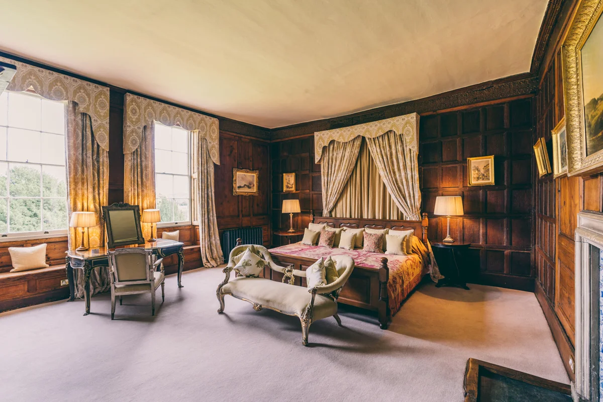 Bridal suite or guest accommodation the master suite at Elmore Court is a beautiful wood panelled room with giant caesar bed and adjoining dressing room