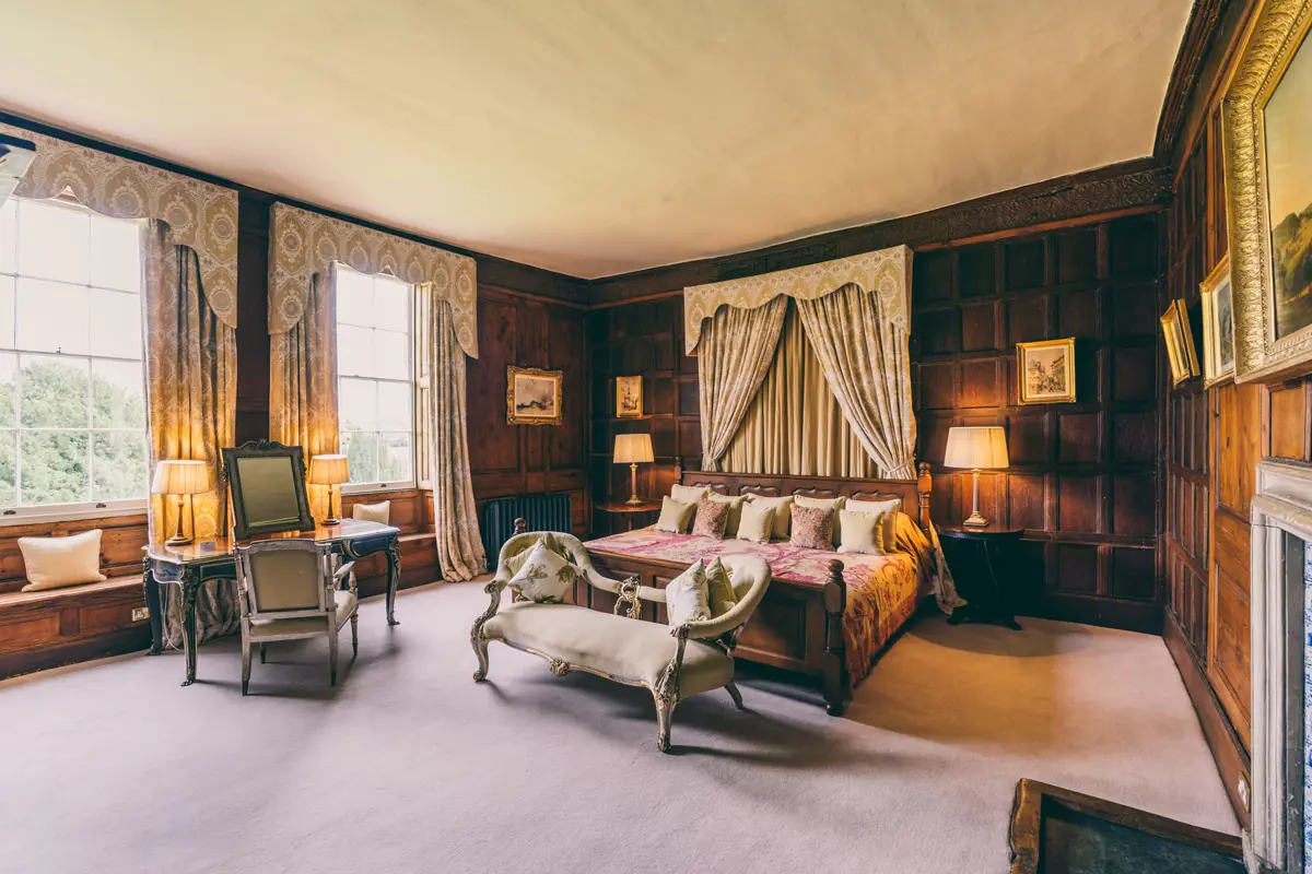 Bridal suite or guest accommodation the master suite at Elmore Court is a beautiful wood panelled room with giant caesar bed and adjoining dressing room