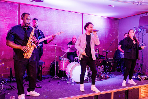 Wedding band with sax on stage at The Gillyflower a wild wedding venue with soundproof party venue at Elmore Court in the Cotswolds