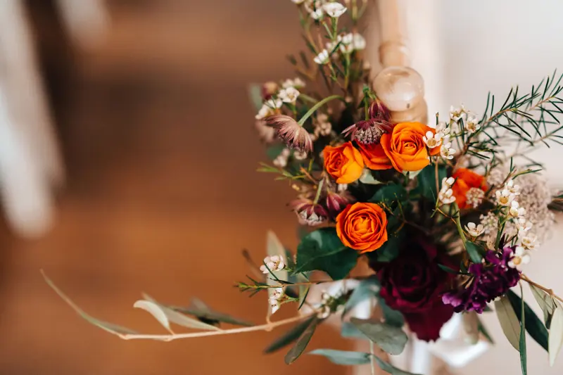 Autumn wedding bouquet with orange roses