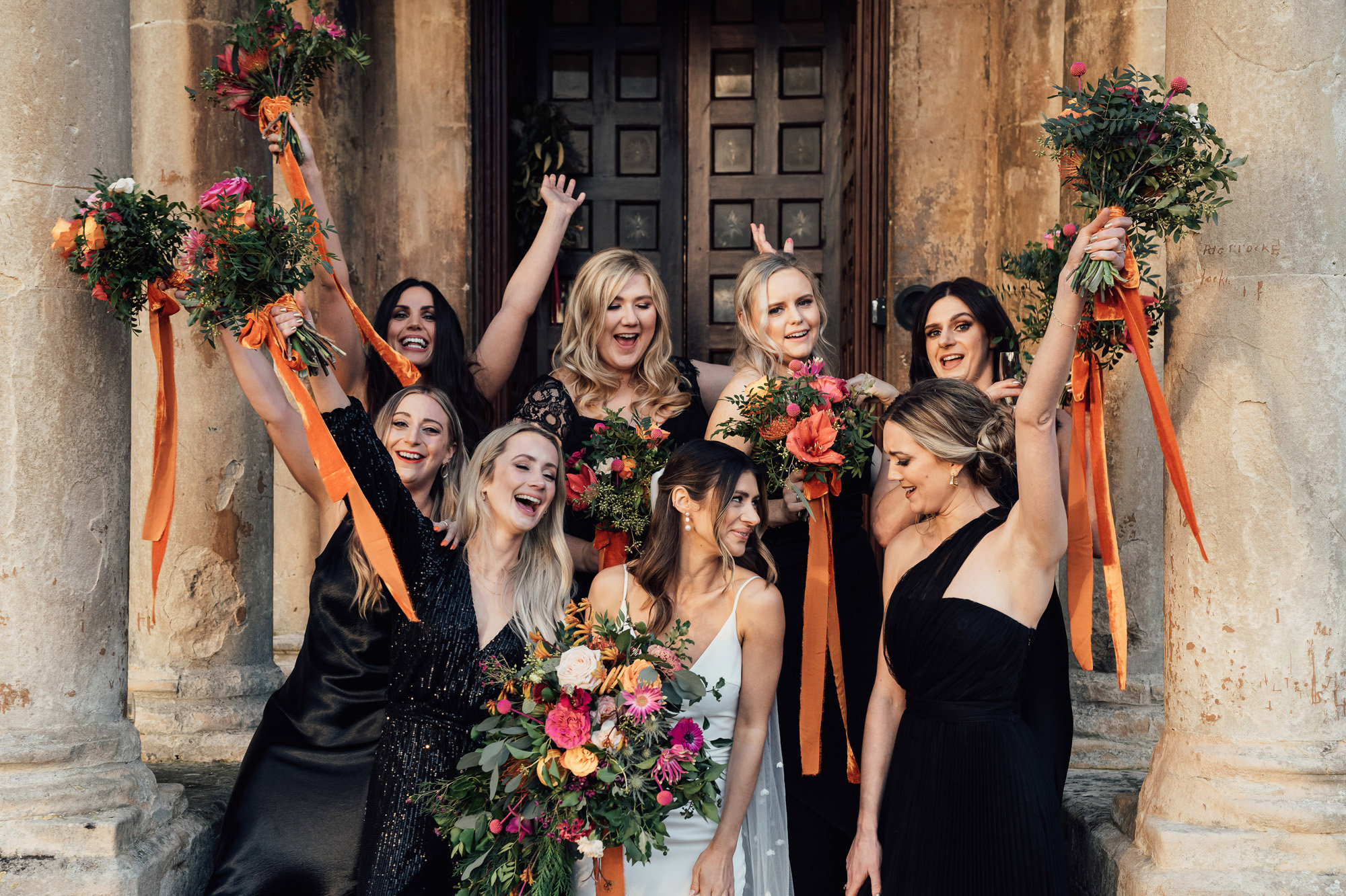 black bridesmaids dresses and bright bouquets for this cool christmas wedding at a stately home in the cotswolds