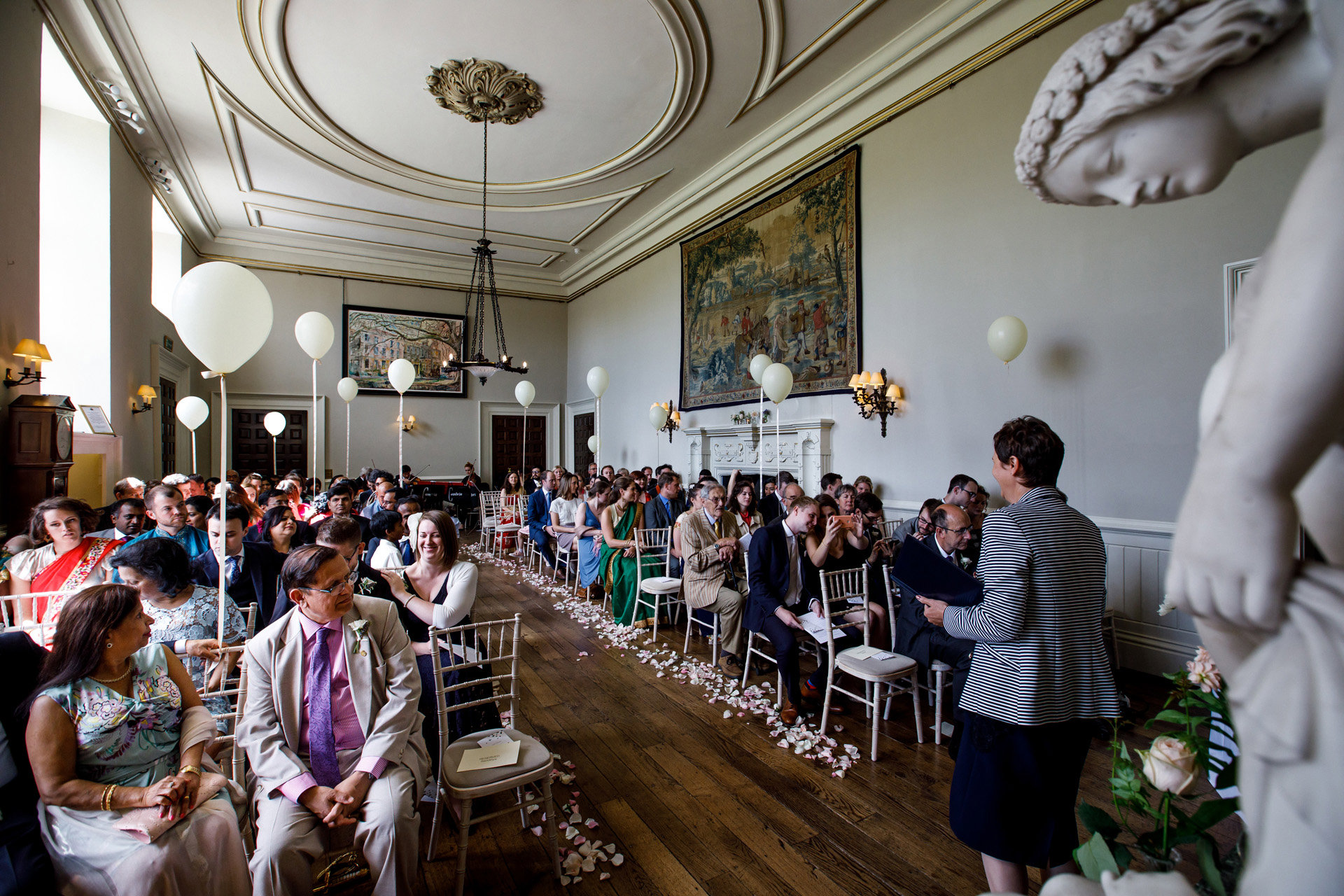 Same sex wedding ceremony hall at mansion Elmore Court decorated with white balloons