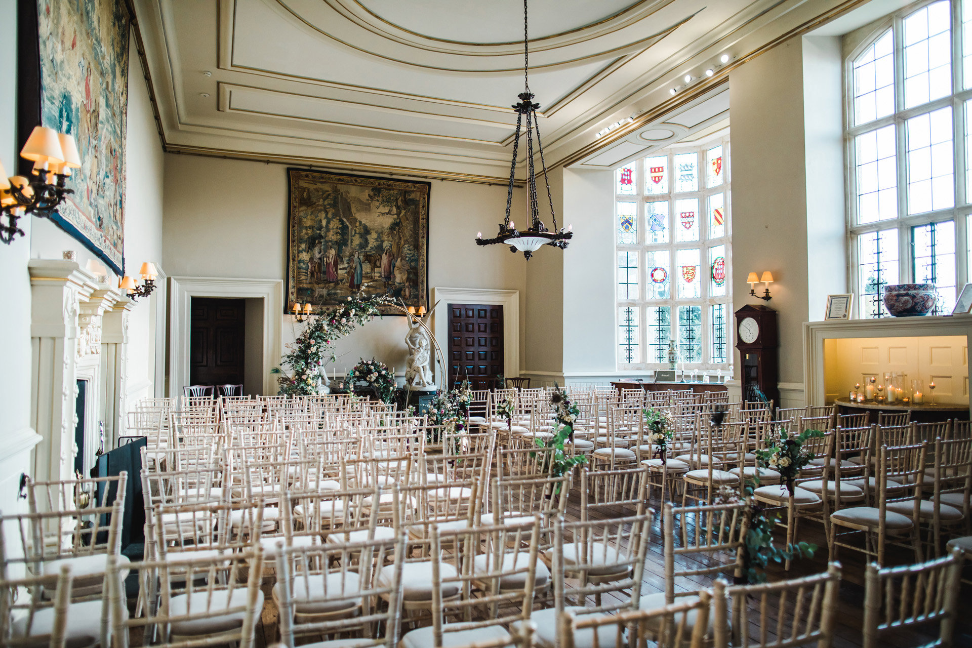 Floral decor and arch decorate the hall for day one of this epic 3 day wedding