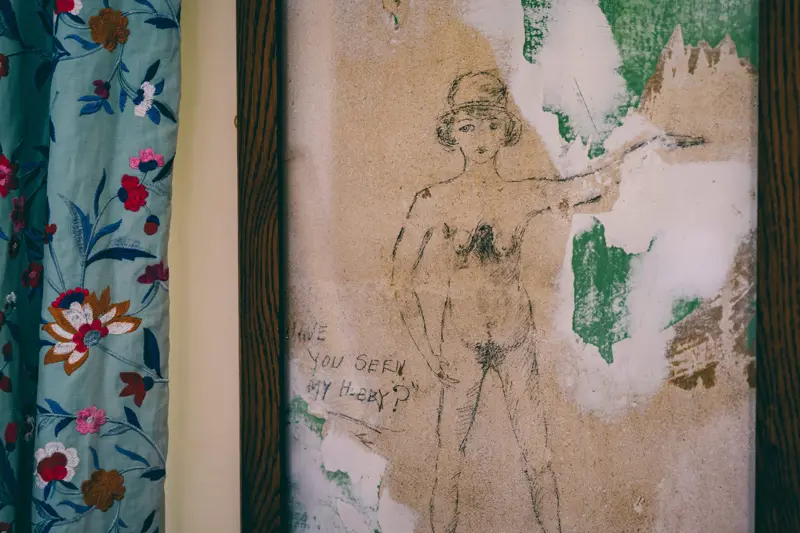 Ancient graffiti of a nude woman found in one of the bedrooms underneath the wallpaper of a stately home wedding venue
