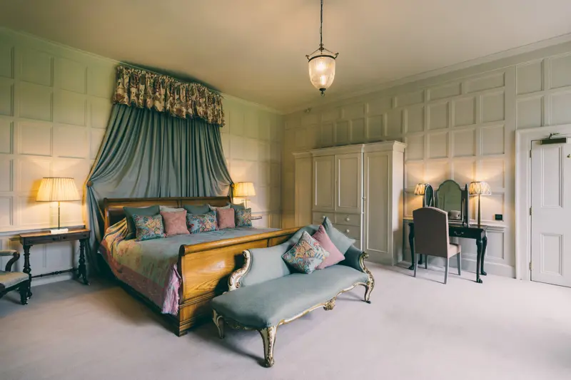 The smoking room white painted panelled room full of light with huge emperor bed could be your bridal suite or guest accommodation