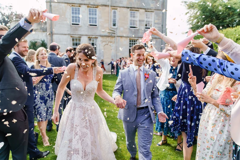 Bride and groom confetti shot on the lawn of stately home elmore court